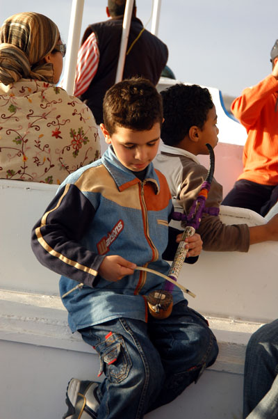 Egyptian boy playing a musical instrument