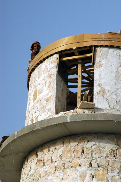 Worker looking over the top of the tower