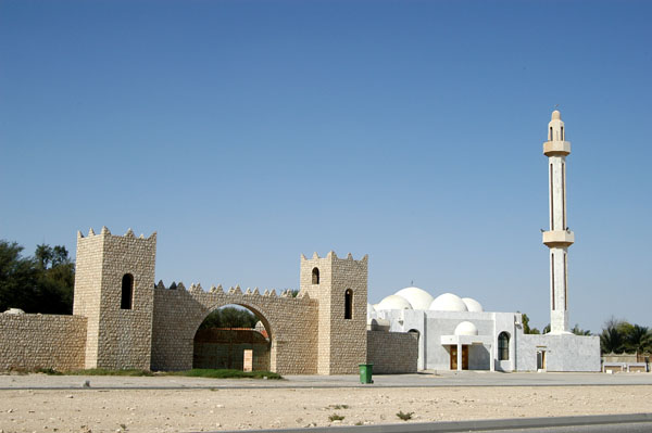 Gate to Al Khor Public Garden and a mosque
