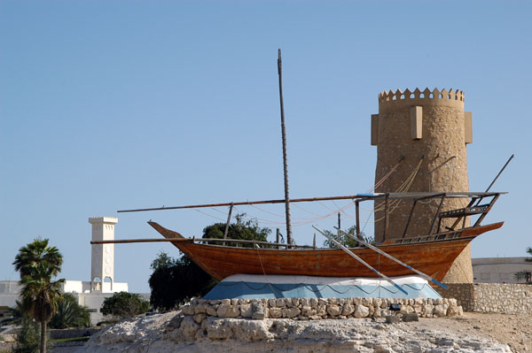 Dhow and watchtower near the Al Khor Corniche