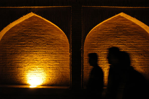 People crossing the Bridge of 33 Arches