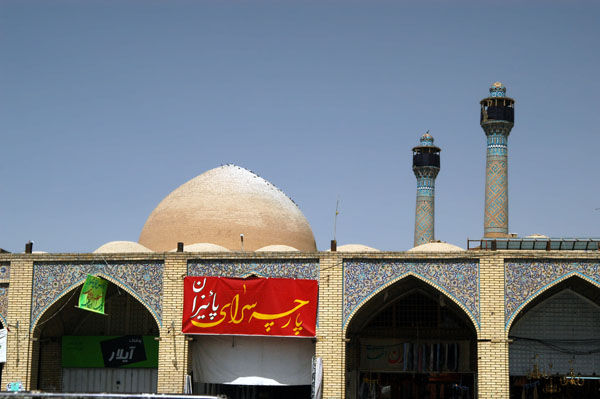 The minarets and domes of the Jameh Mosque rising behind part of Isfahan's bazaar