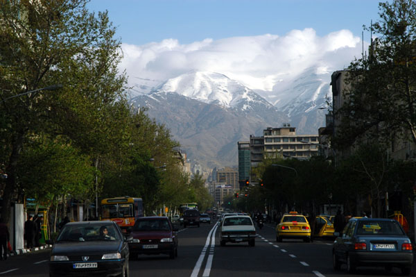 Ferdosi Street with a view of the cloud and snow covered Alborz Mountains