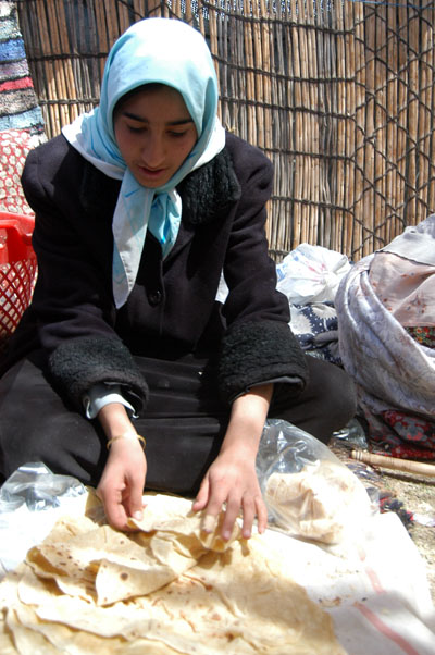 Nomad girl preparing bread