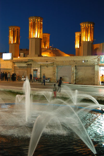 Fountain and windtowers at night
