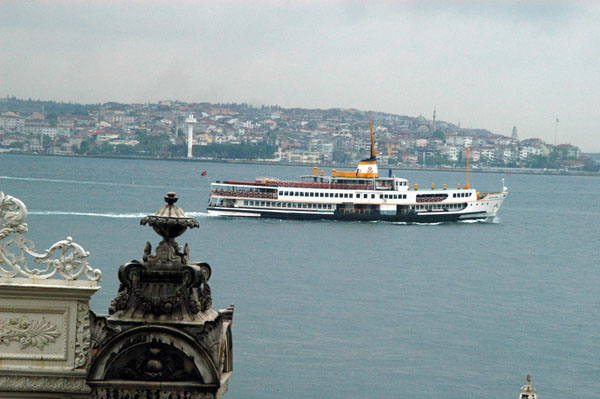 Turkish ferry on the Bosphorus passing Dolmabahce Palace