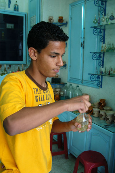 Boy selling perfumes near the Medersa Slimanya