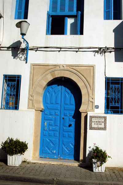 Typical Tunisian blue door on white house