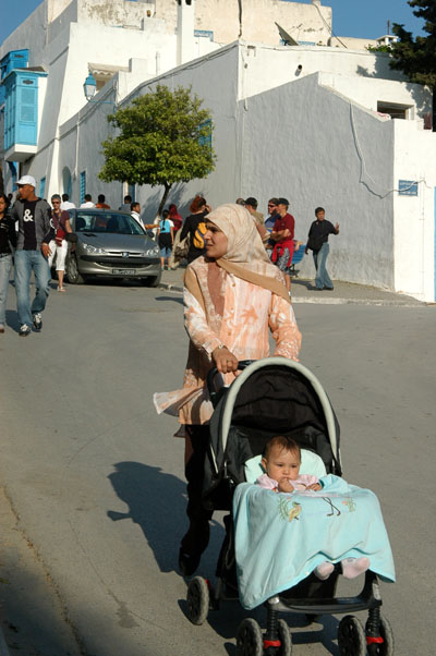 Tunisian woman pushing a stroller, Sidi Bou Said
