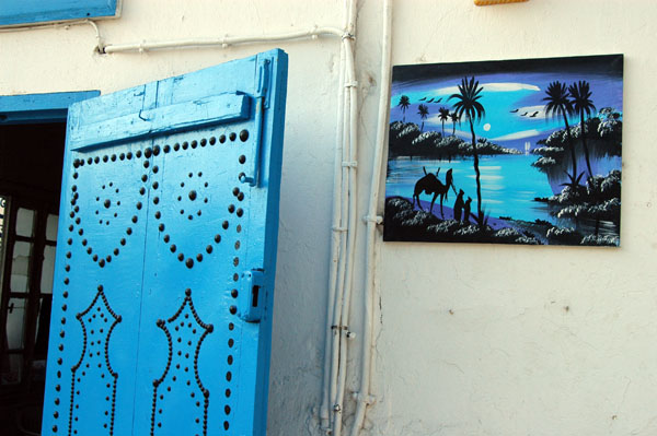 Blue door of a shop selling paintings