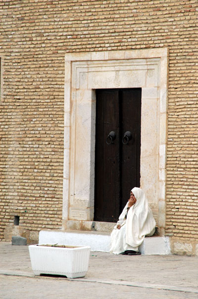 Woman sitting by a door