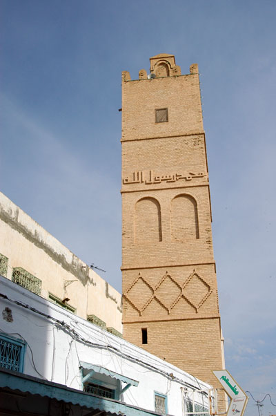 Mosque minaret with Arabic script in brickwork