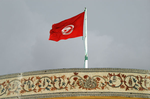 Tunisian flag over a mosaic covered roof, El Jem