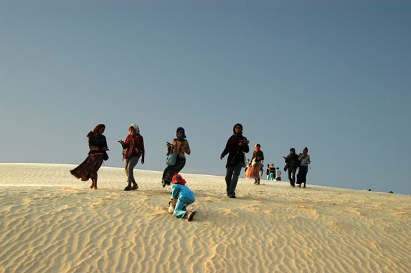 As we arrive at the largest dune, we're accosted by women selling trinkets