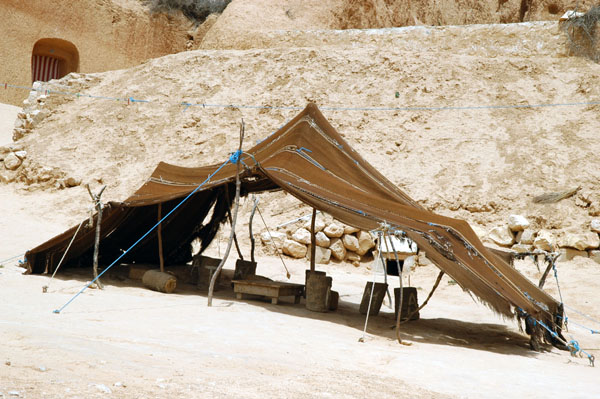 Traditional nomadic black hair tent set up outside a troglodyte dwelling near Matmata