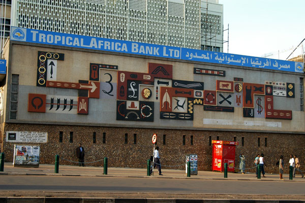 The side of the bank is covered with a large mosaic depicting various currencies in use throughout history