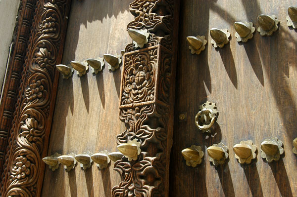Carving and metal studs on a stone town door