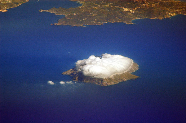 Cloud cap sitting on top of Andimilos, Cyclades, Greece