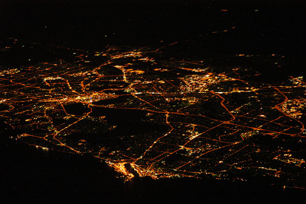 High altitude aerial of Perth at night with Freemantle at the bottom centre of the frame