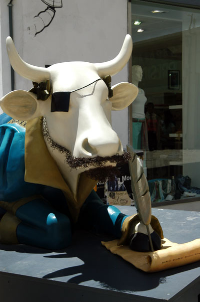 Cow writing with feather pen