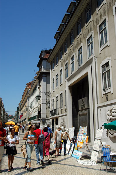 Pedestrians glancing at the art on offer, Rua Augusta