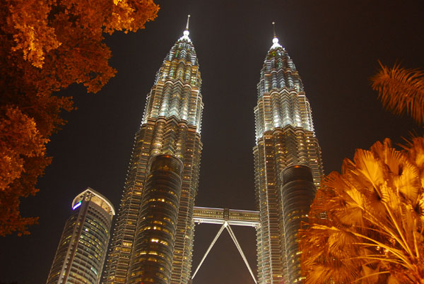 Petronas Towers, Kuala Lumpur, at night, with some trees
