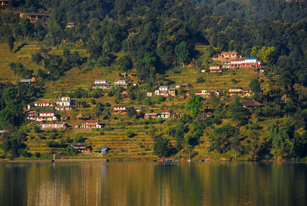 Traditional houses and terraced fields on the opposite shore of Lake Phewa