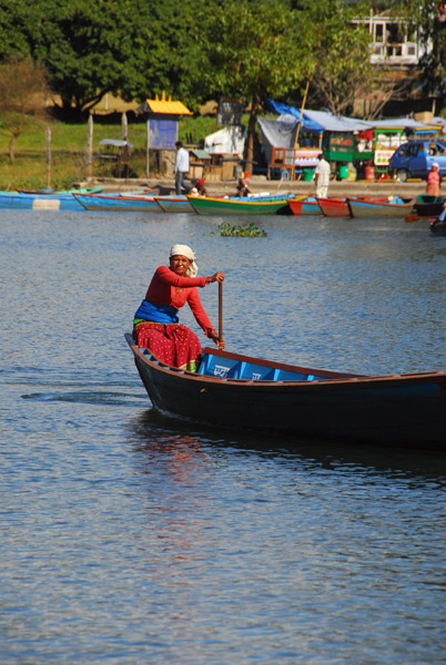 Woman padding a boat, Lake Phewa