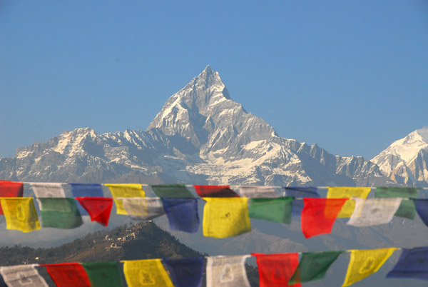 Machhapuchhare and prayer flags from the hilltop viewpoint near World Peace Pagoda