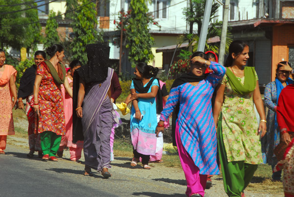 Nepali women in colorful clothing and one with a full face veil, Chitwan Province