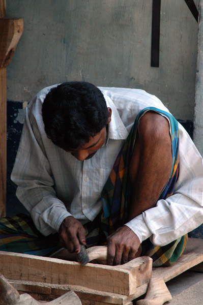 Craftsman at work shaping wooden parts, Old Dhaka