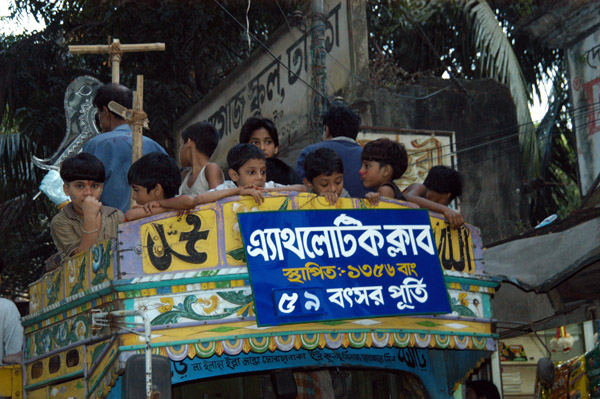Kids riding on thop of a truck during the Hindu Street festival, Dhaka