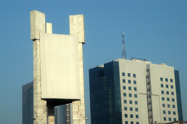 Monument at the start of Airport Road with the UTC Building on Pantha Path, Dhaka