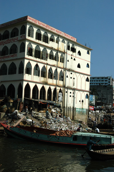 Barge filled with broken bricks pulled up on the riverbank