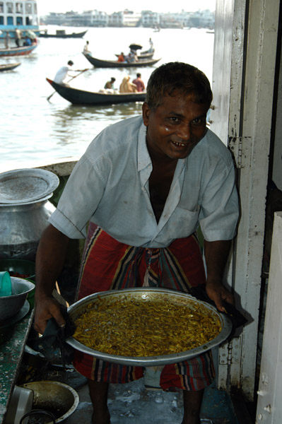 The cook on one of the big boats preparing a meal (with river water)