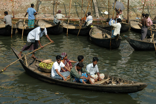 Sampan setting across the river off with five passengers while the other wallahs wait patiently