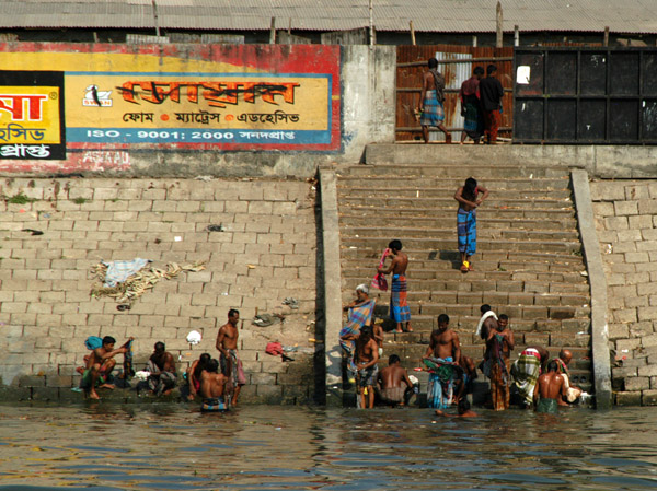 Bangladeshi men bathing along the ghat (the steps leading down to the river) Dhaka