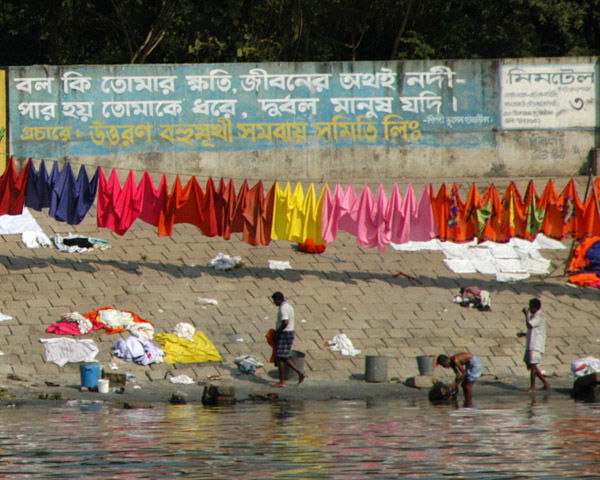 Textiles from the factory set out along the riverbank with the colors all nicely sorted