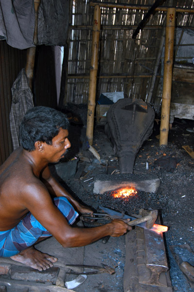 Blacksmith with his forge set up in a hut, Fatulla Market