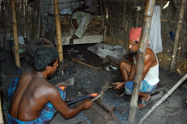 A pair of blacksmiths working a piece of red hot iron, Fatulla
