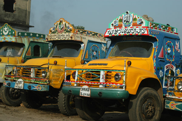Painted Bangladeshi Bedford trucks parked on the side of the road to Dhaka