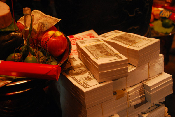Offerings including stacks of fake US $100 bills