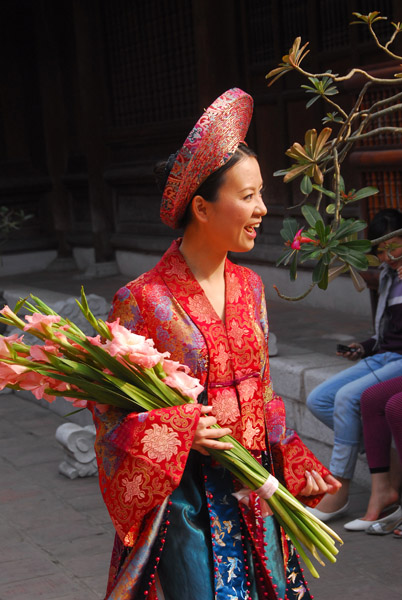 Woman in a traditional dress with flowers, Temple of Literature
