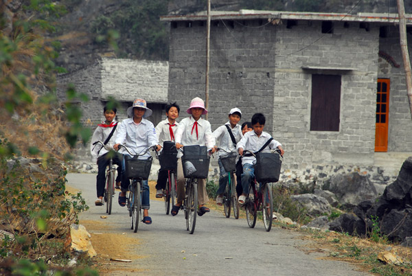Vietnamese school children pedaling home, Hoa Lu