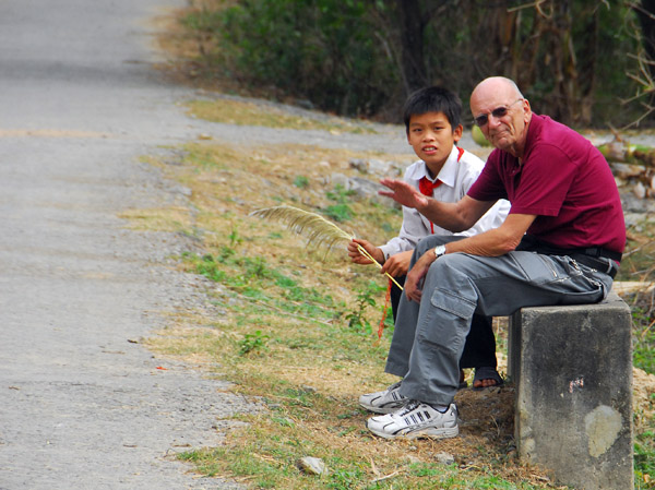 Dad taking a rest with a Vietnamese boy whose only English word is money