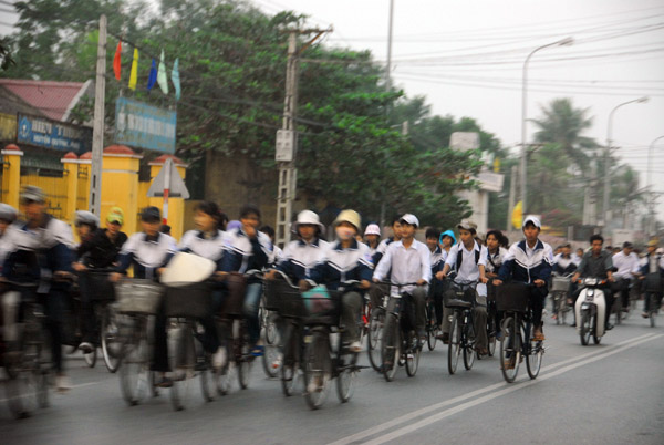 Rush hour of bicycles - children riding home after school let out at 5pm