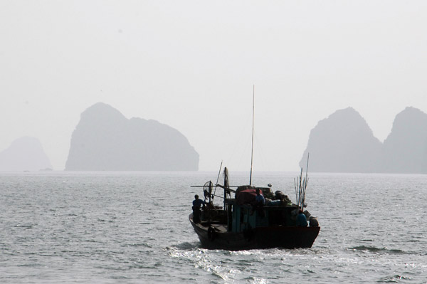 Fishing boat with some of the islands around Cat Ba Harbor