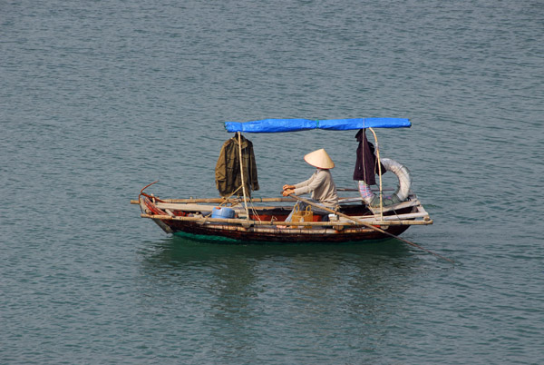 Vietnamese woman rowing out to the floating village, Cat Ba