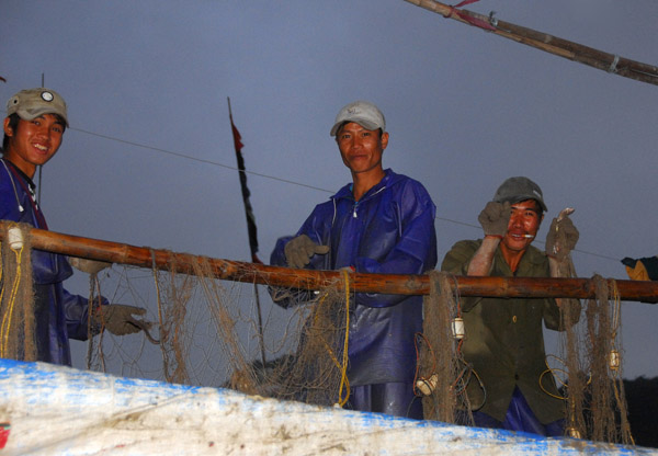 Vietnamese fishermen preparing their nets, Cat Ba Harbor