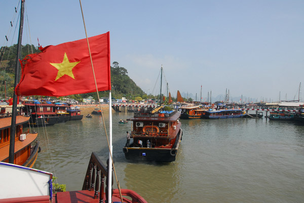 Vietnamese flag and the Bai Chay tourist port, Halong City